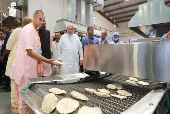 Checking how the roti-making machine makes close thousands of rotis